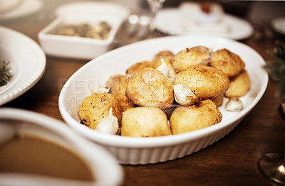Buy stock photo Shot of a bowl of roast potatoes  on a table at Christmas
