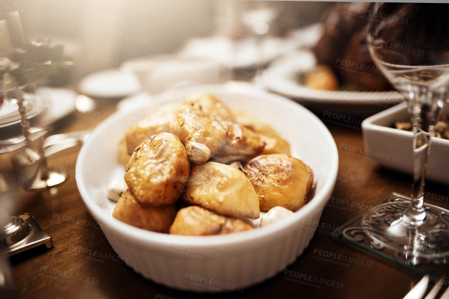Buy stock photo Shot of a bowl of roast potatoes  on a table at Christmas