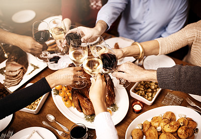 Buy stock photo Cropped shot of a group of people making a toast over Christmas lunch