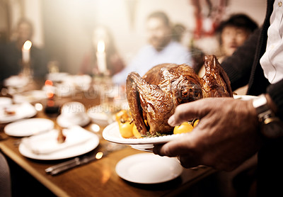 Buy stock photo Cropped shot of an unrecognizable person serving a roasted turkey at Christmas lunch