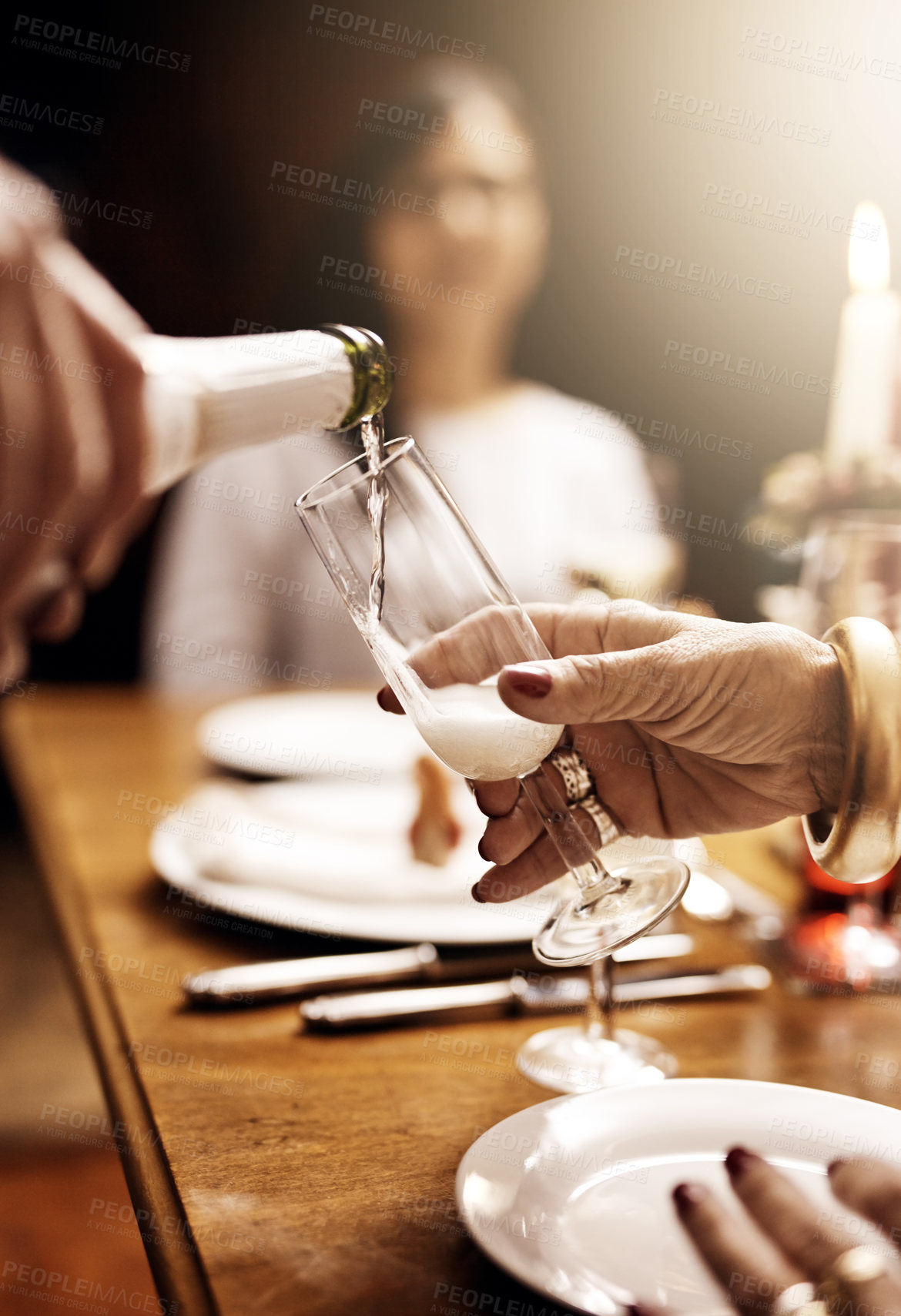 Buy stock photo Cropped shot of an unrecognizable person pouring a glass of champagne at Christmas lunch