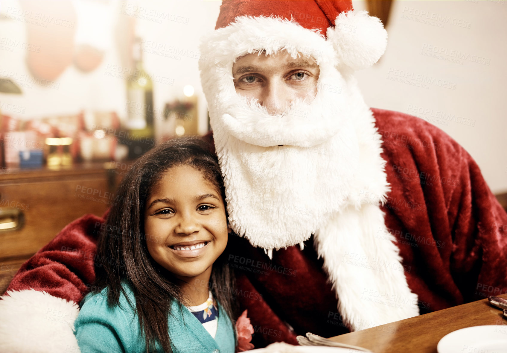 Buy stock photo Portrait of an adorable little girl enjoying Christmas with her dad dressed up as Santa at home
