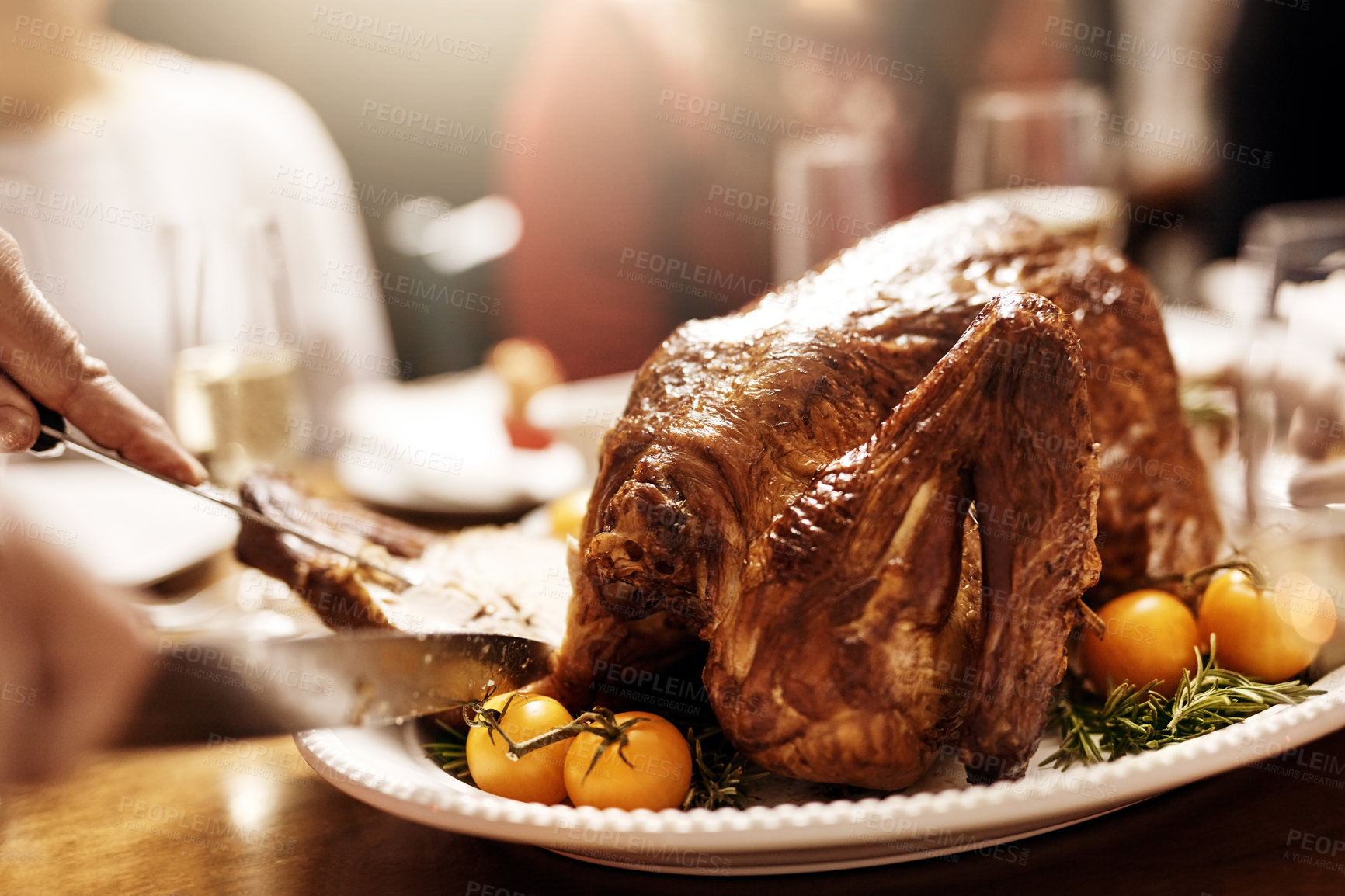 Buy stock photo Hands, turkey and cutting for feast, family and meat for reunion of people, dinner or thanksgiving. Chicken, fork and knife for slice, holiday or celebration in dining room, Christmas or food in home