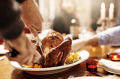 Buy stock photo Cropped shot of an unrecognizable person cutting into a turkey at Christmas lunch