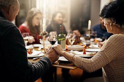 Buy stock photo Food, thanksgiving and hand holding with family at table in dining room for holiday, prayer or worship. Celebration, support and gratitude with people praying at home for kindness, dinner and love