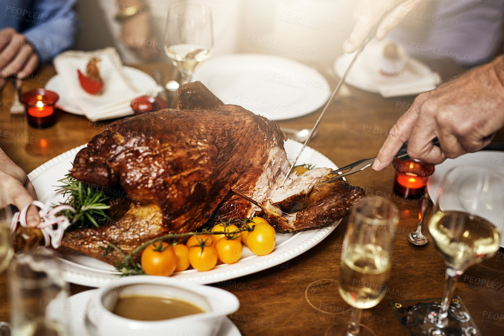 Buy stock photo Cropped shot of an unrecognizable person cutting into a turkey at Christmas lunch