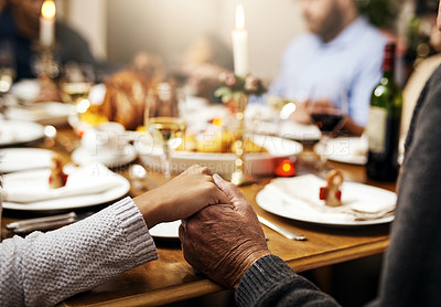 Buy stock photo Closeup, thanksgiving and hand holding with family at table in dining room for holiday, food or worship. Celebration, support and gratitude with people praying at home for kindness, dinner and love