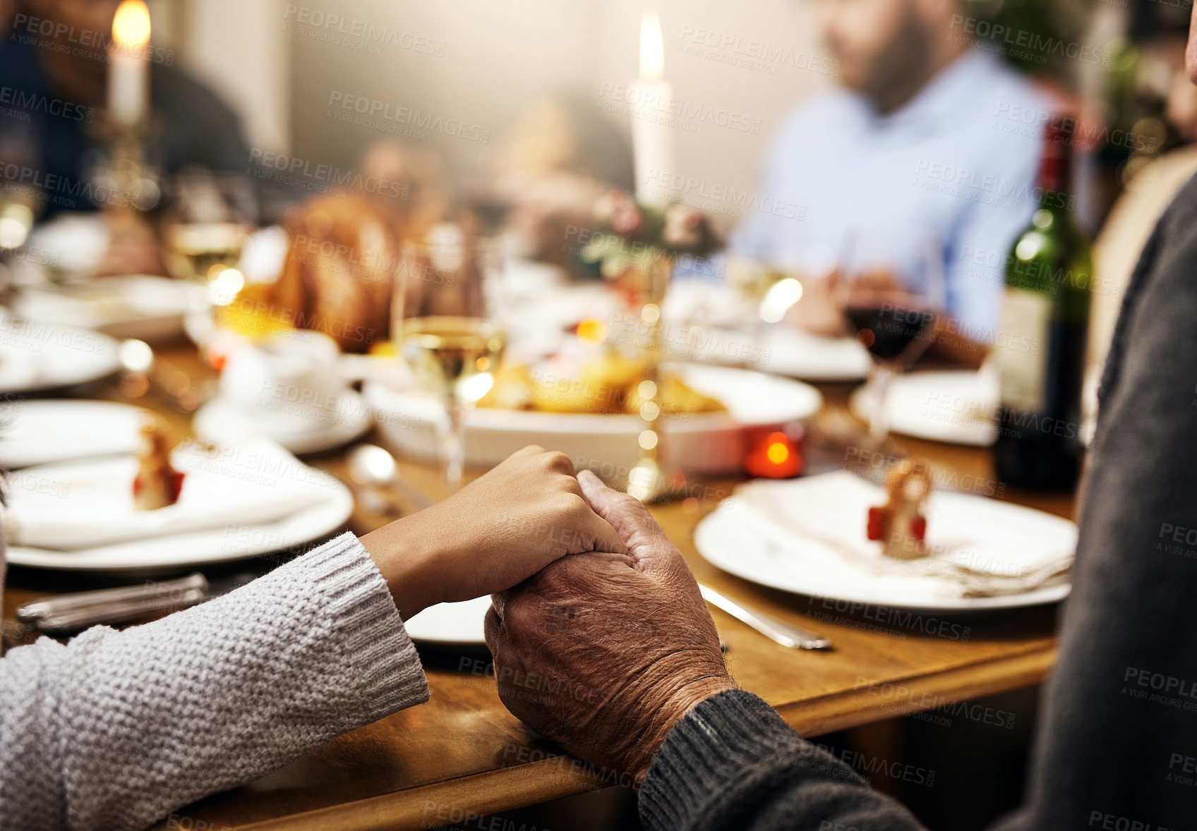 Buy stock photo Closeup, thanksgiving and hand holding with family at table in dining room for holiday, food or worship. Celebration, support and gratitude with people praying at home for kindness, dinner and love