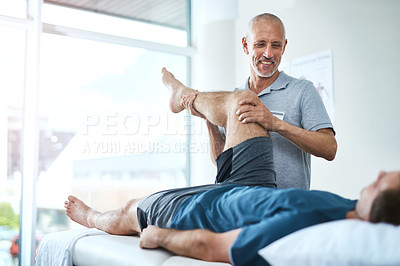 Buy stock photo Healthcare, physiotherapist and patient with leg injury, stretching and recovery with treatment, healing or care. Male person, employee or chiropractor with a client, physical therapy or consultation