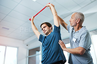 Buy stock photo Resistance band, stretching or training and man with physiotherapist in office for appointment or checkup. Exercise, fitness and physiotherapy professional with strong patient in rehab clinic