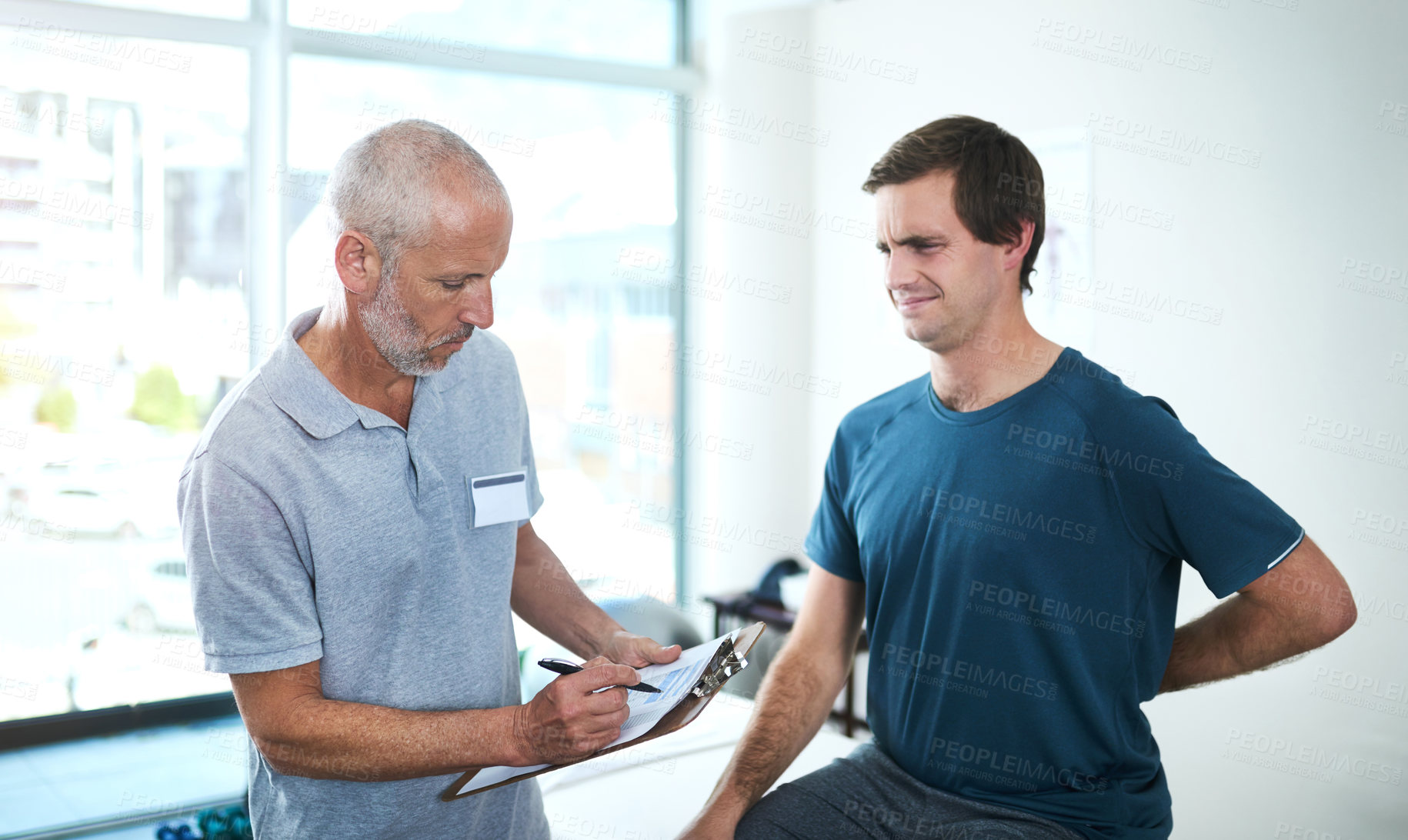 Buy stock photo Mature man, physiotherapist and patient with back pain, injury or writing on clipboard for healthcare. Physical therapy, chiropractor and help client with spine problem or arthritis in medical clinic