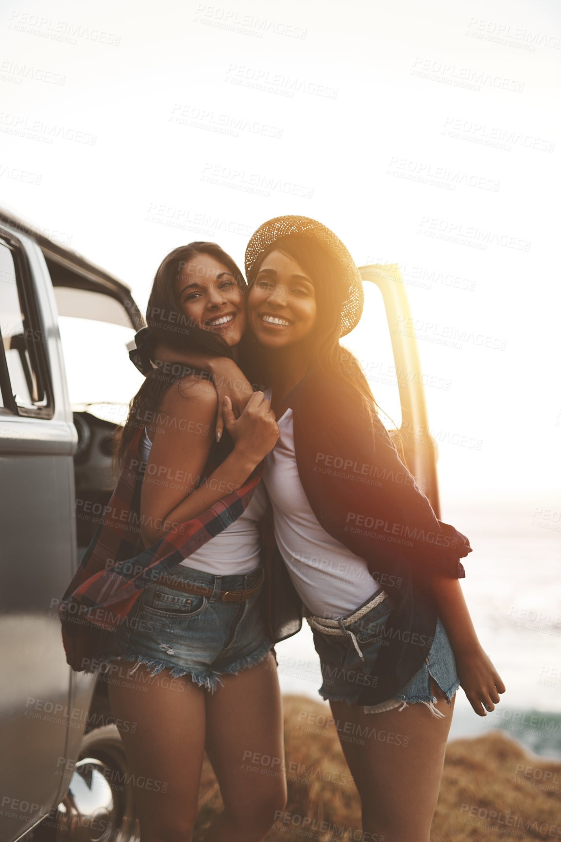 Buy stock photo Road trip, friends and portrait of women at beach for holiday, summer vacation and bonding on weekend. Travel, nature and happy people by ocean for adventure, hug and relax together by sea with van