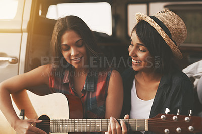 Buy stock photo Friends, guitar and happy for road trip, fun and adventure in van with music, hat or lens flare. Women, hipster and relax for travel, vacation and journey outdoor with smile, singing or song in car