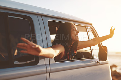 Buy stock photo Shot of a young woman leaning out of her van's window with her arms outstretched