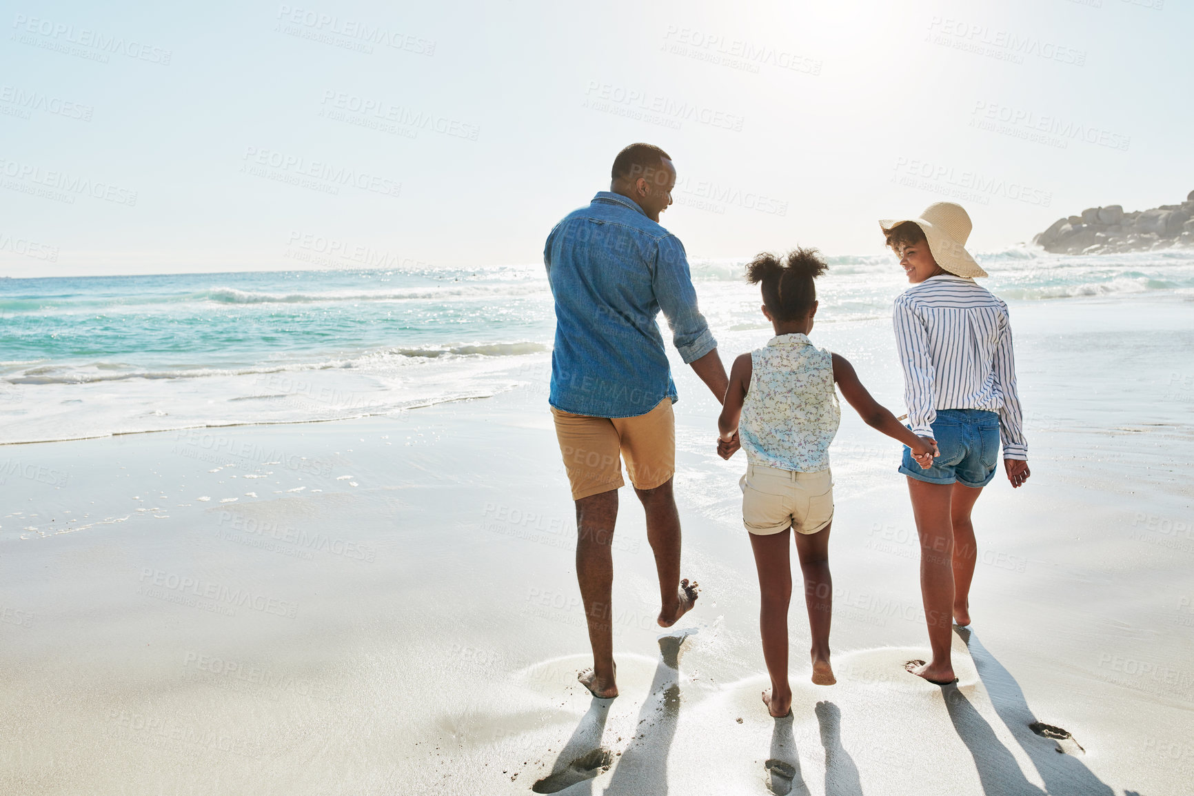 Buy stock photo Black family, beach and walk during summer on vacation or holiday relaxing and enjoying peaceful scenery at the ocean. Sea, water and parents with daughter, child or kid with childhood freedom