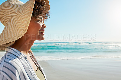 Buy stock photo Shot of a young woman enjoying a day at the beach