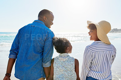 Buy stock photo Black family, back and holding hands with girl on beach for bonding, holiday or outdoor weekend. African mother, father or kid walking in sunshine together for fun summer by ocean coast in nature