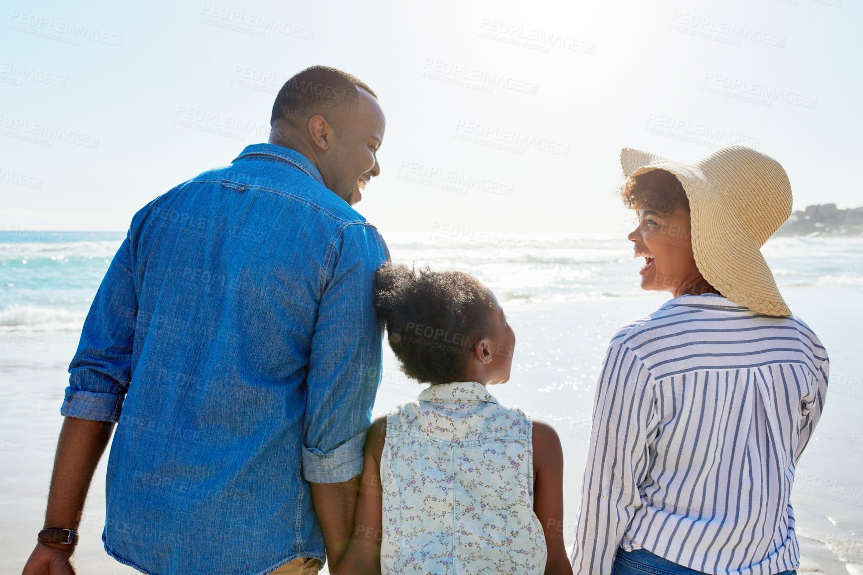 Buy stock photo Black family, back and holding hands with girl on beach for bonding, holiday or outdoor weekend. African mother, father or kid walking in sunshine together for fun summer by ocean coast in nature