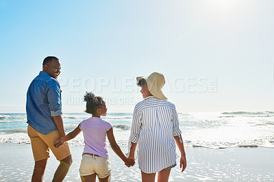 Buy stock photo Family, parents and holding hands on beach for holiday, vacation and support, love or security. Back of excited dad, mom or people with child walking together by sea for travel, adventure and bonding