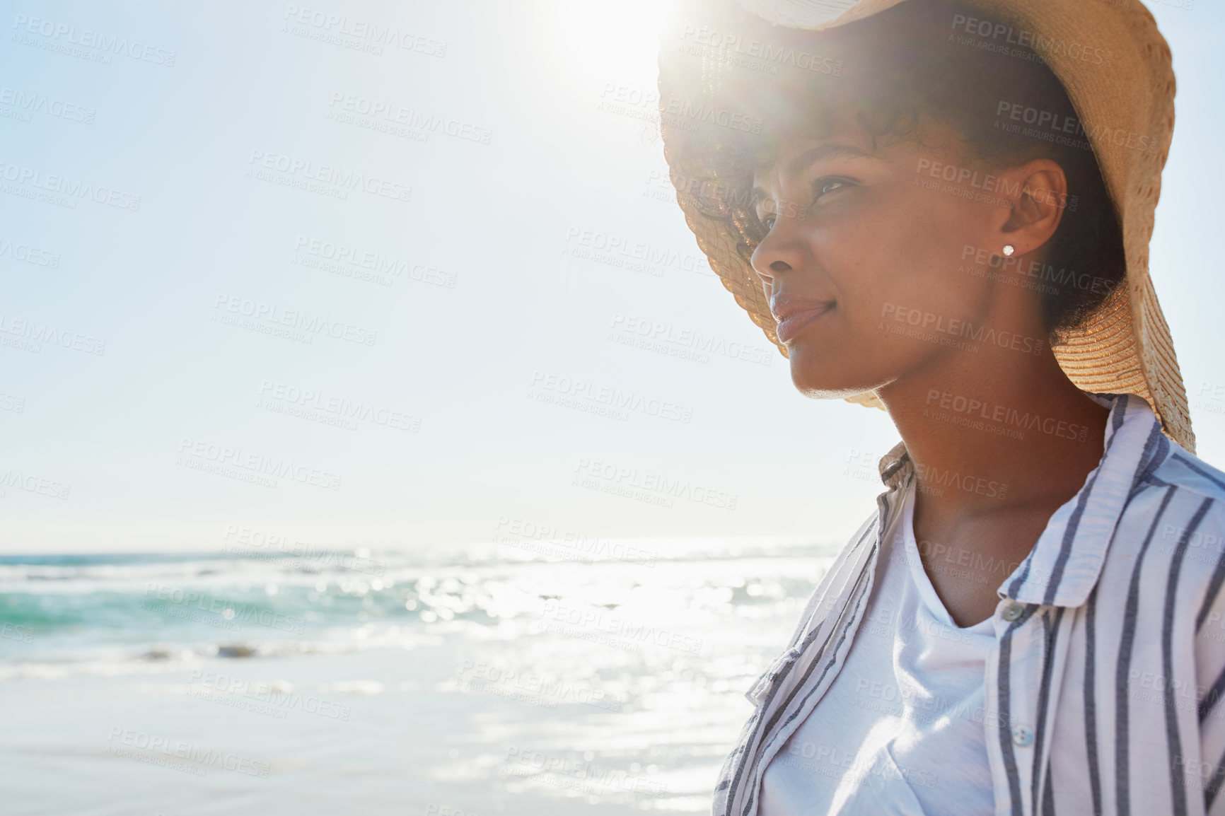 Buy stock photo Shot of a young woman enjoying a day at the beach