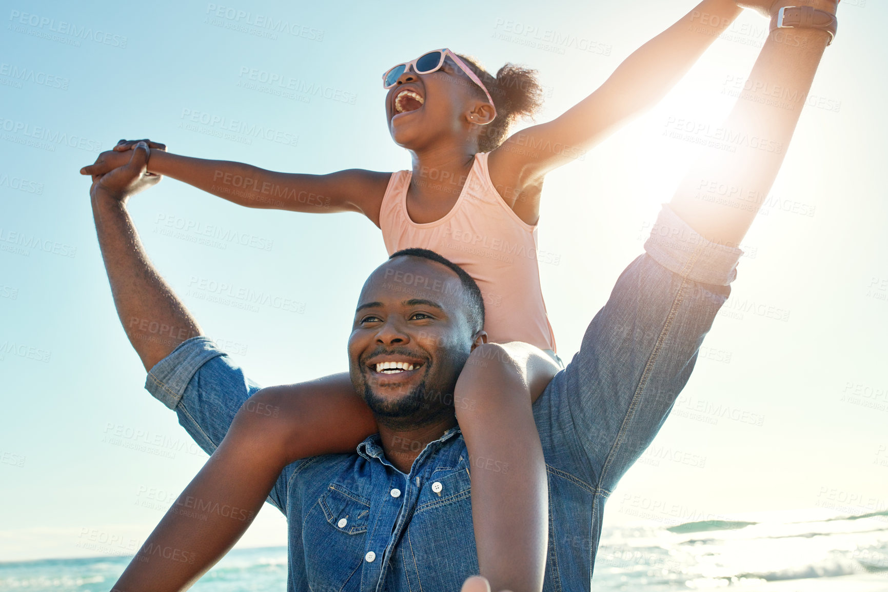 Buy stock photo Summer, beach and girl on shoulder of father enjoying holiday, vacation and freedom on weekend. Black family, travel and happy dad and child smile on adventure for bonding, relaxing and fun by ocean