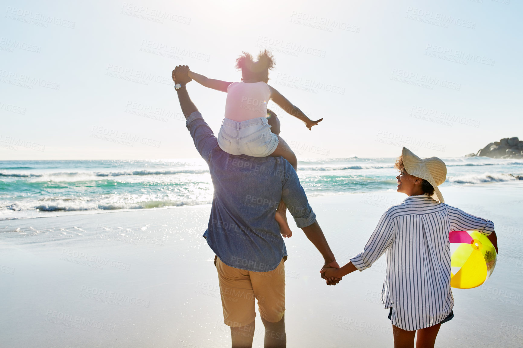 Buy stock photo Happy family, shoulder and holding hands with child on beach for bonding, holiday or outdoor weekend. African mother and father carrying daughter for fun summer together by ocean coast in nature