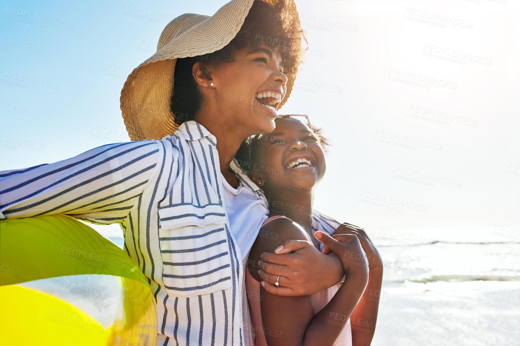 Buy stock photo Shot of an adorable little girl having fun with her mother  on the beach