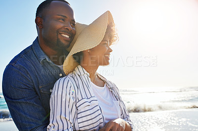 Buy stock photo Happy, black couple and hug with sunshine at beach for holiday, travel or outdoor weekend in nature. African man and woman with smile in joy for summer time, bonding or vacation day by ocean coast