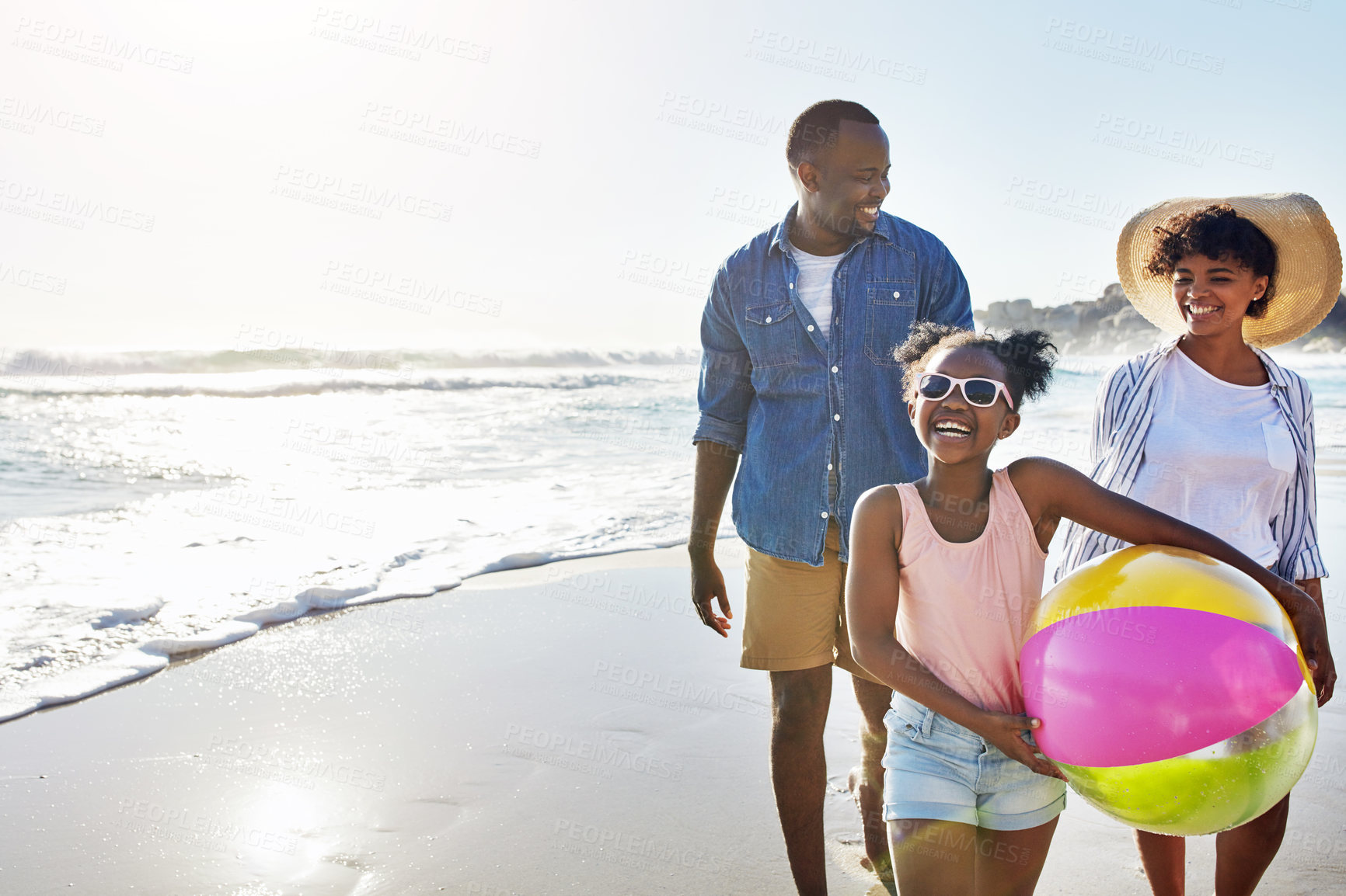 Buy stock photo Black family, kids or beach with a mother, father and daughter carrying a ball while walking on the sand by the sea. Love, nature and ocean with a man, woman and girl child on the coast in summer