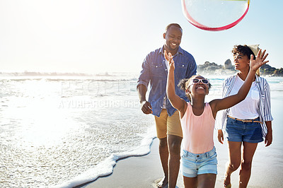Buy stock photo Shot of an adorable little girl having fun with her parents on the beach