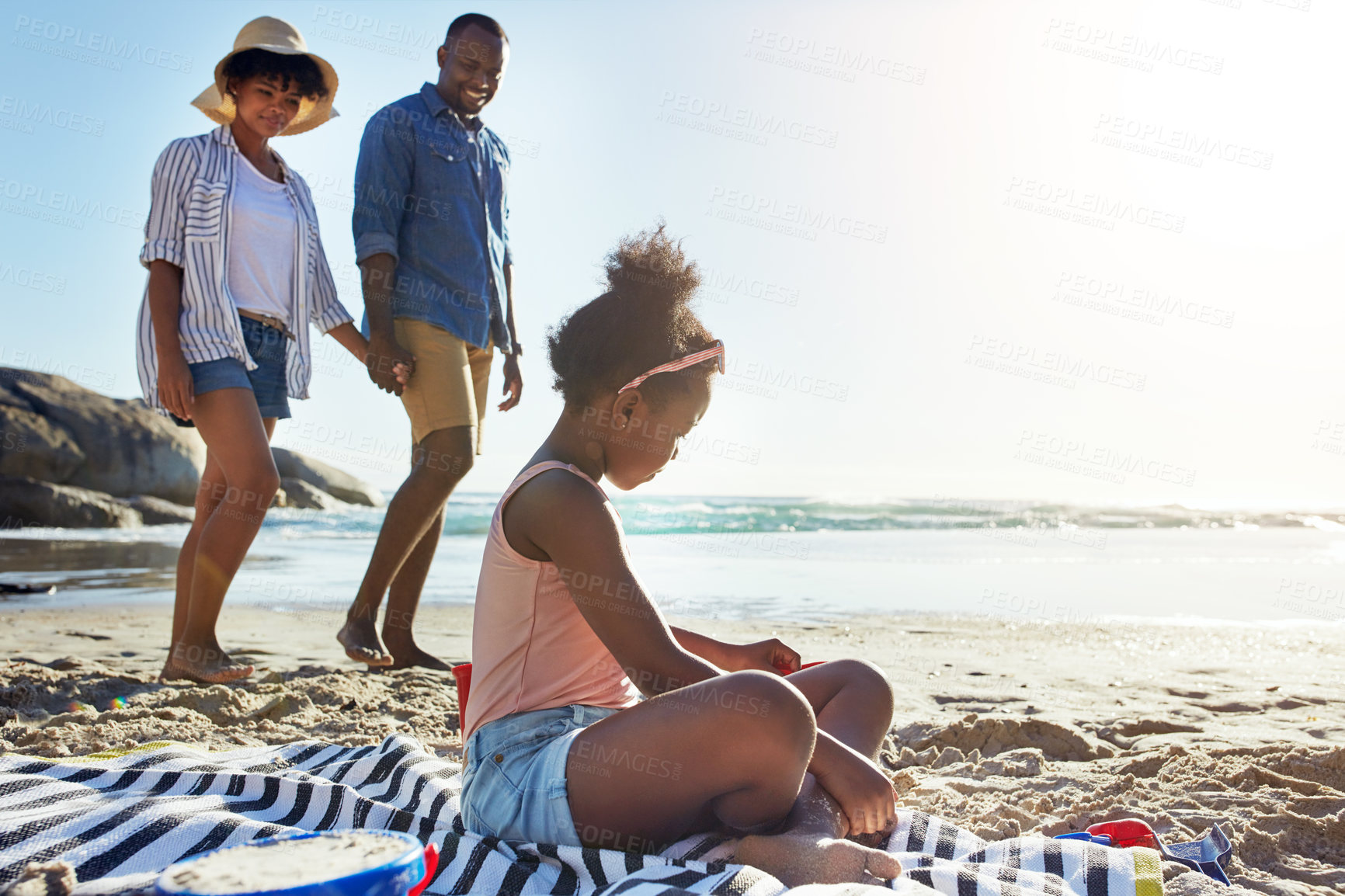 Buy stock photo Fun, relax and girl at the beach with parents for holiday, summer and travel in Portugal. Freedom, playful and black family at the ocean for a vacation, fresh air and coastal trip at the sea