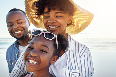 Buy stock photo Shot of an adorable little girl having fun with her parents on the beach