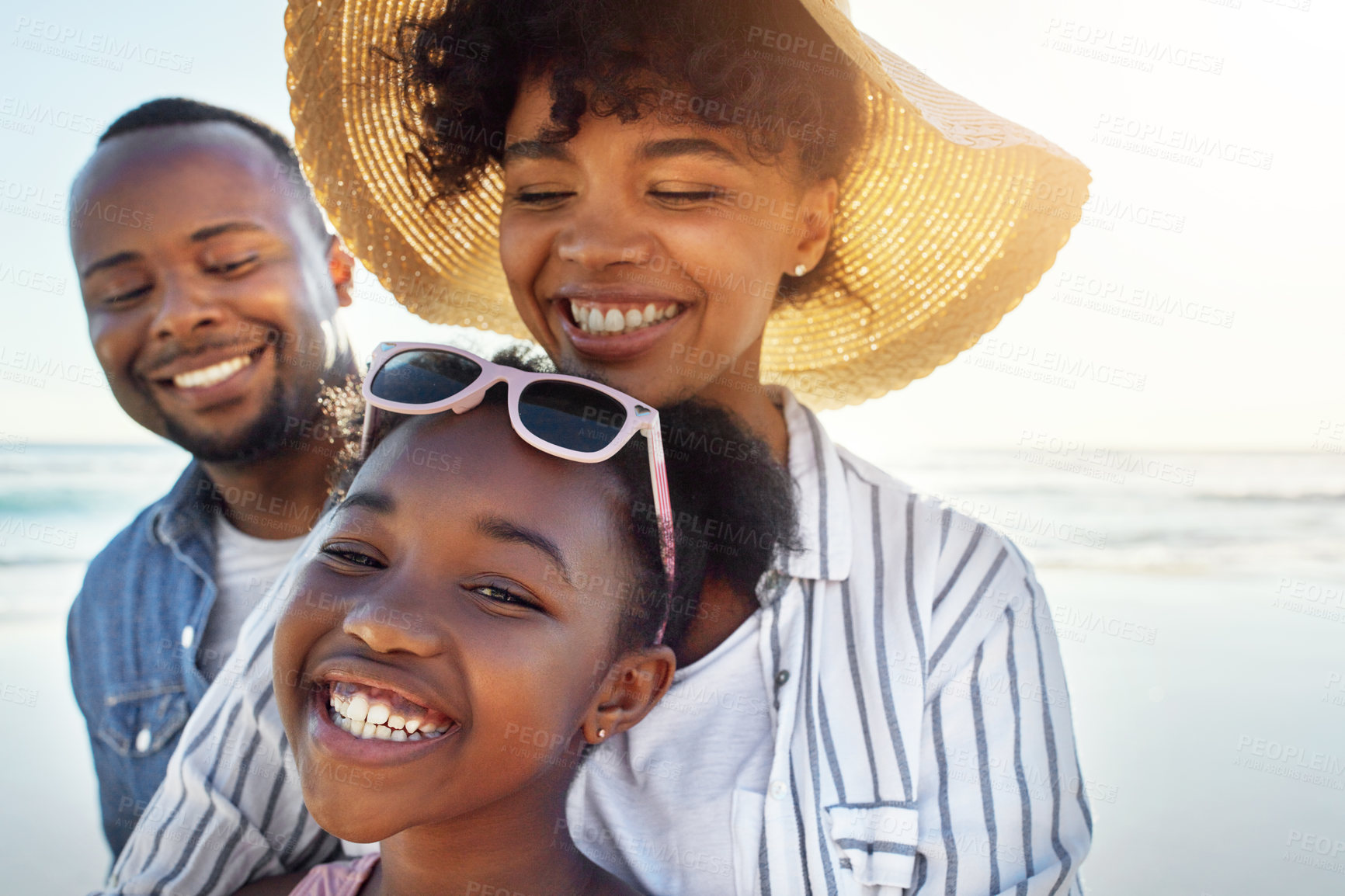 Buy stock photo Shot of an adorable little girl having fun with her parents on the beach