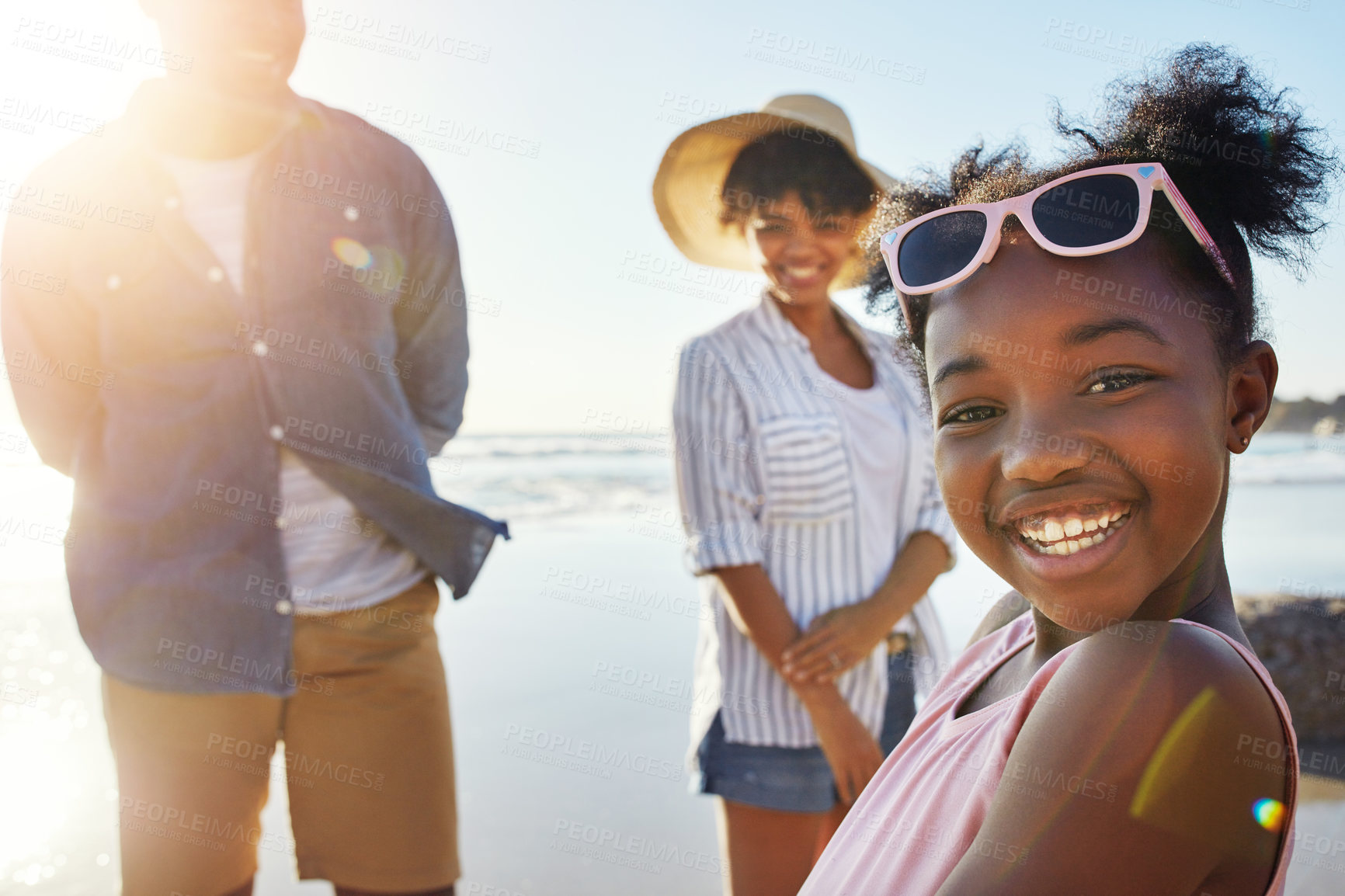 Buy stock photo Shot of an adorable little girl having fun with her parents on the beach