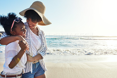 Buy stock photo Shot of an adorable little girl having fun with her mother  on the beach