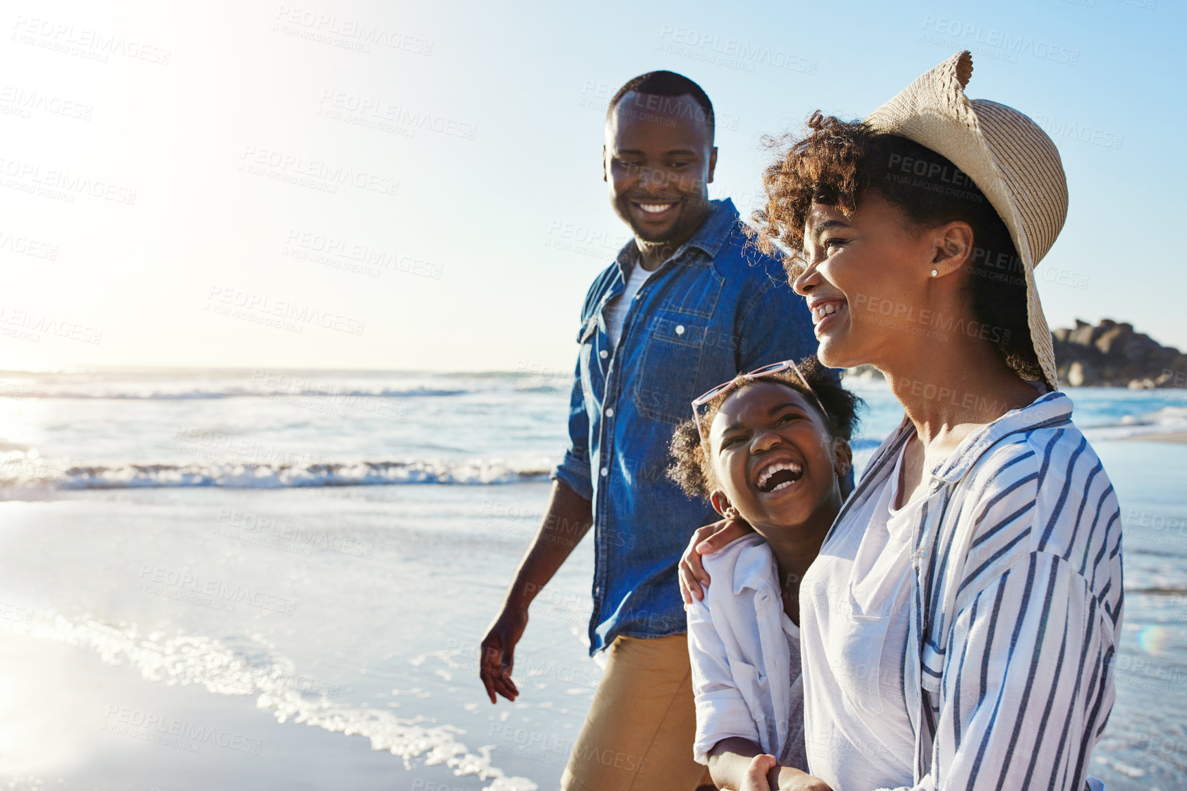 Buy stock photo Shot of an adorable little girl going for a walk with her parents on the beach