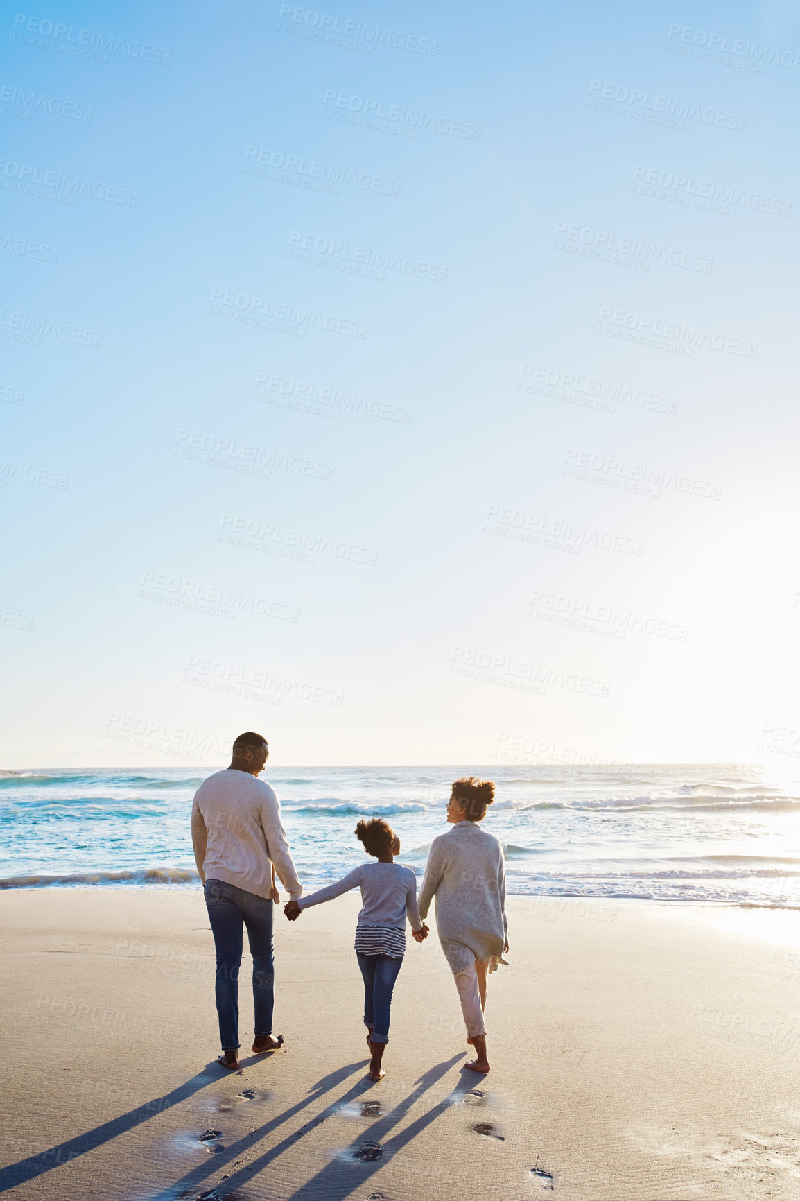 Buy stock photo Family, beach and walk during sunset on vacation or holiday relaxing and enjoying peaceful scenery at the ocean. Sea, water and parents with daughter, child or kid with childhood freedom