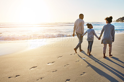 Buy stock photo Black family, sunset and beach walk during summer on vacation relaxing at a peaceful scenery by the ocean. Sea, footprints and parents with daughter, child or kid with childhood freedom