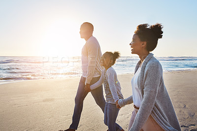 Buy stock photo Black family, sunset and walking on the beach by happy child and parents on vacation or holiday. Sea, ocean and travel with African daughter or kid holding hands together near water