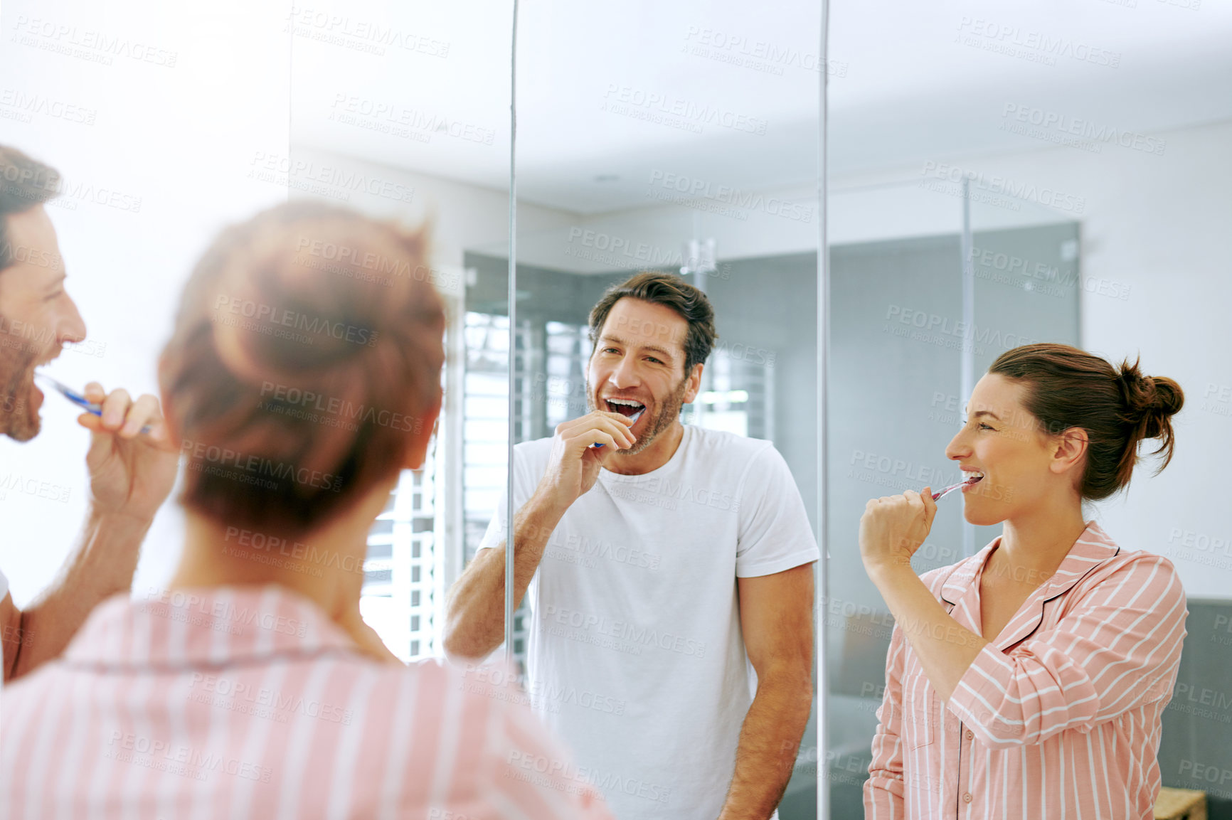 Buy stock photo Brushing teeth, cleaning and mirror with couple in bathroom for oral hygiene, morning and dental. Self care, wellness and toothbrush with man and woman at home for gum treatment, toothpaste or health