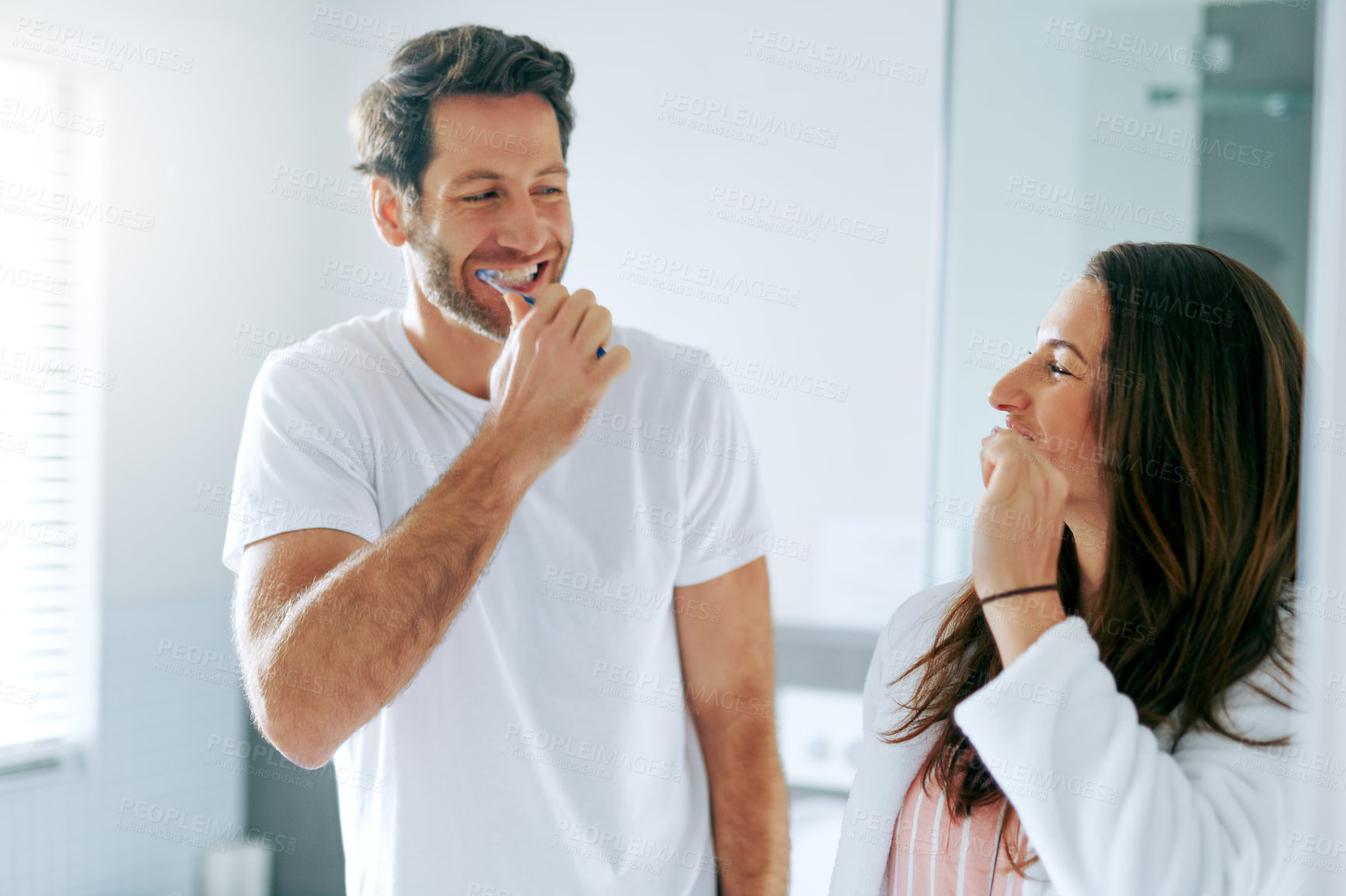 Buy stock photo Brushing teeth, dental and morning with couple in bathroom for oral hygiene, breath and cleaning. Self care, wellness and toothbrush with man and woman at home for gum treatment, toothpaste or health