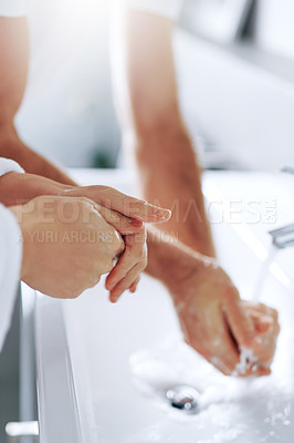 Buy stock photo Cropped shot of a couple washing their hands in the basin at home