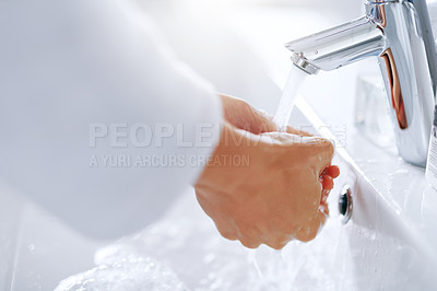 Buy stock photo Cropped shot of an unrecognizable woman washing her hands