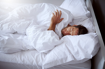 Buy stock photo Cropped shot of a middle-aged man sleeping peacefully in his bed
