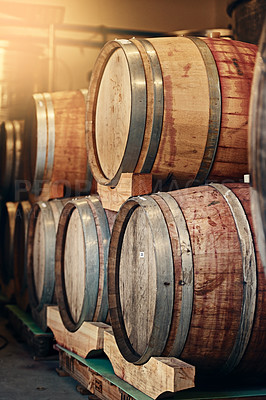 Buy stock photo Cropped shot of barrels of wine stacked on each other in a wine distillery