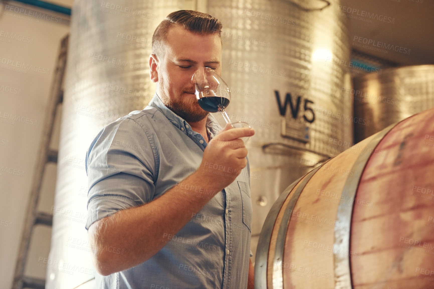 Buy stock photo Aroma, glass and test with man in wine cellar for industry, manufacturing or production. Barrel, smelling and storage with sommelier at winery for distillation or fermentation scent of alcohol