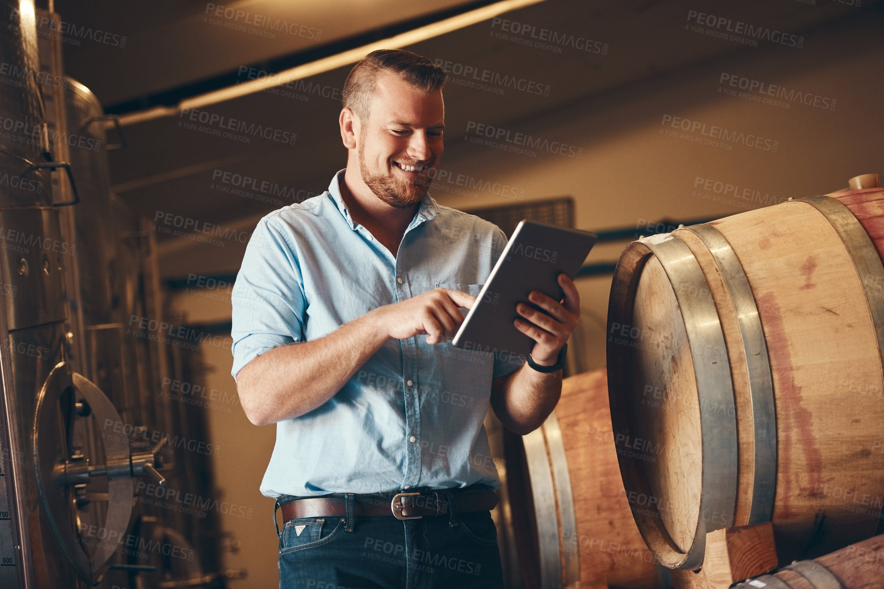 Buy stock photo Business, man and proud with tablet in brewery as manager with smile on product, process and schedule for supplier. Employee, barrel and happy for beer production, manufacturing or craft in factory