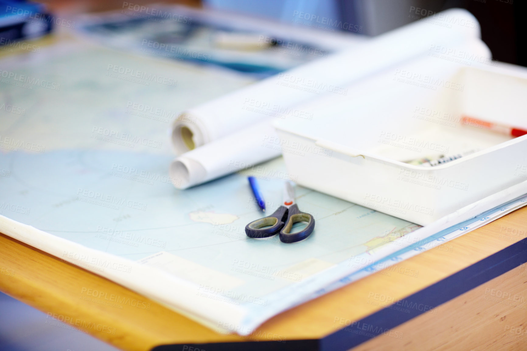 Buy stock photo High angle shot of a map and stationary lying on a desk inside a lifeguard office