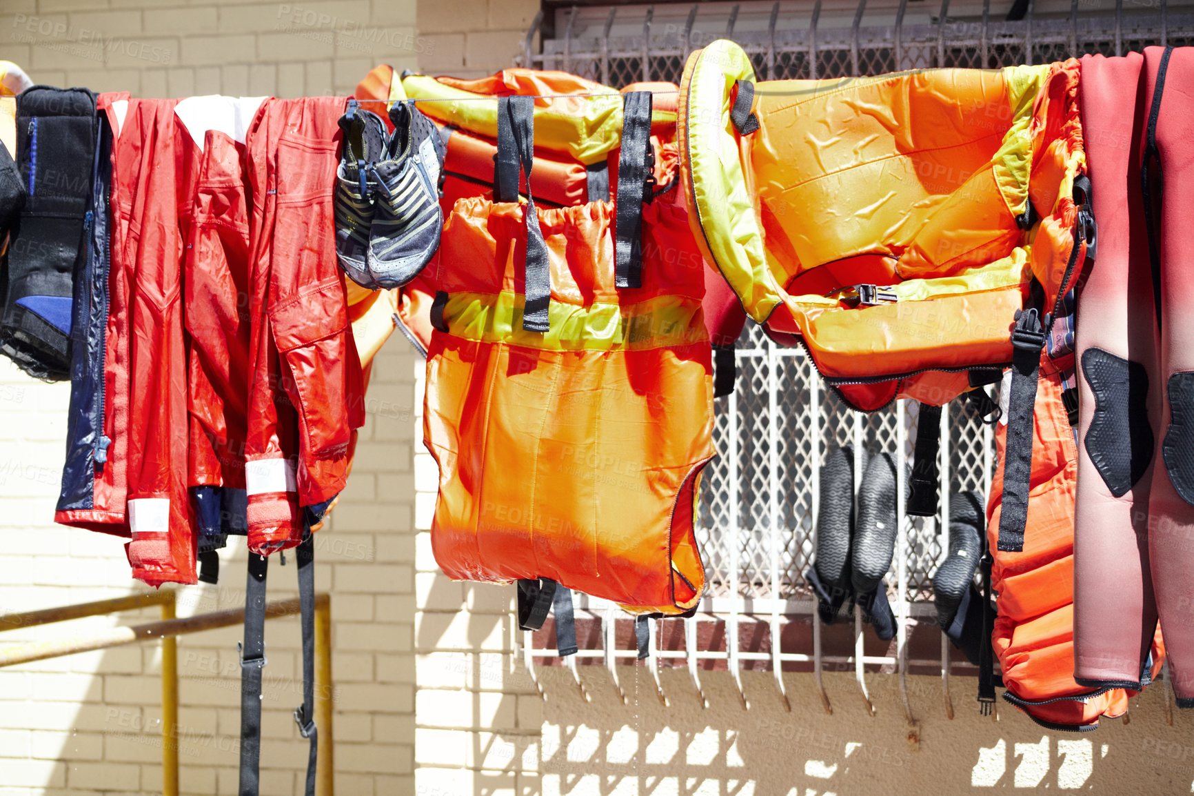 Buy stock photo Cropped shot of lifeguard gear hanging on a washing line outside