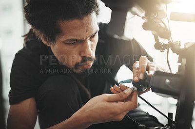 Buy stock photo Behind the scenes shot of a camera operator shooting a scene with a state of the art camera inside of a studio during the day